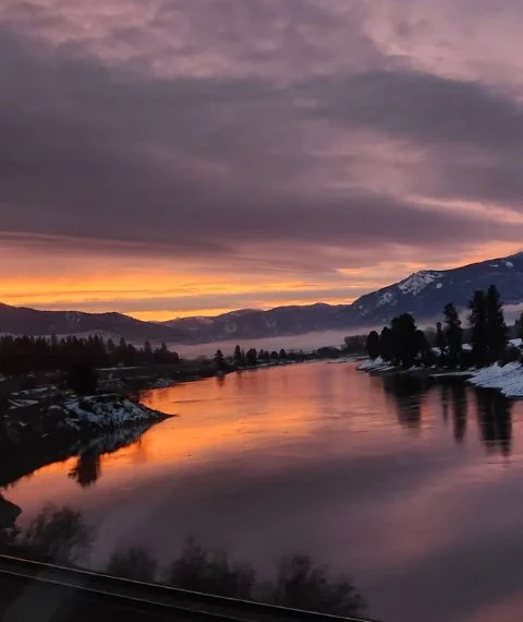 Sunset over the river in Western Montana, with snow on the banks